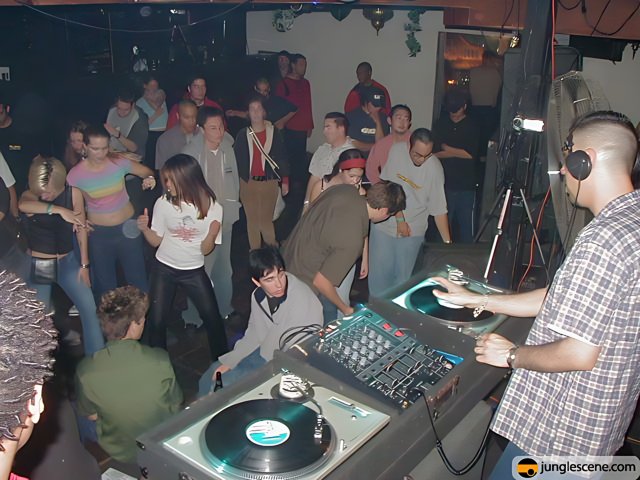 Nightclub DJ Entertains Crowded Room with Music