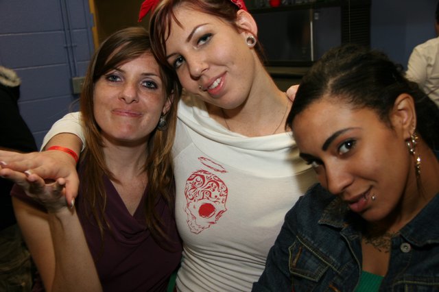 Three Friends Posing Together at a Party