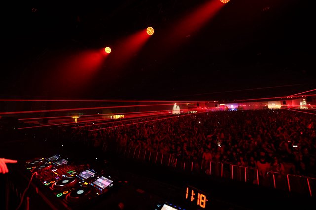 Massive Crowd Electrified by Red Laser Light Show