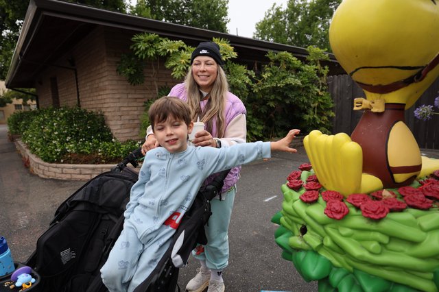 Child Reaches for Woodstock Statue at Balloon Festival