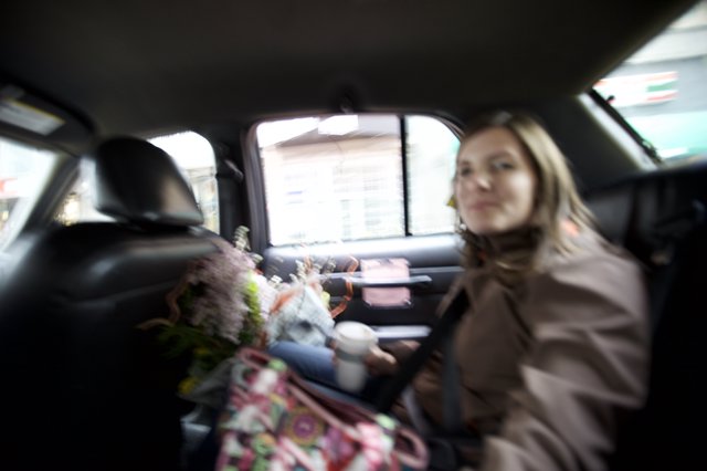 Woman in Taxi with Flowers on Valentine's Day