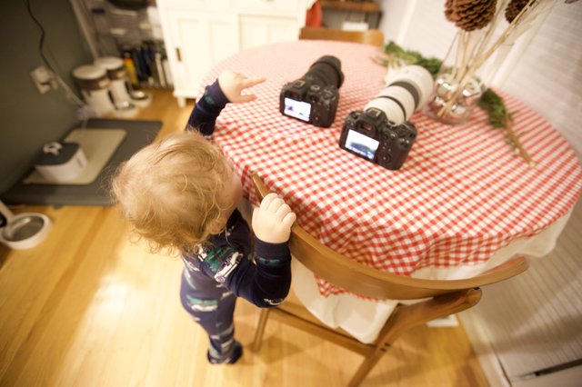 Curious Toddler Explores Photography Equipment on Christmas