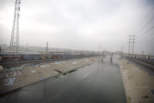 Graffiti-clad River with Train