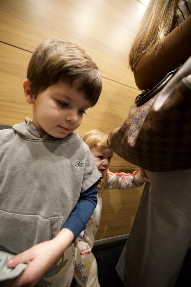 Children Exploring Museum Statue with Parent