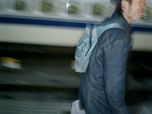 Man Walking in Front of Train at Tokyo Station