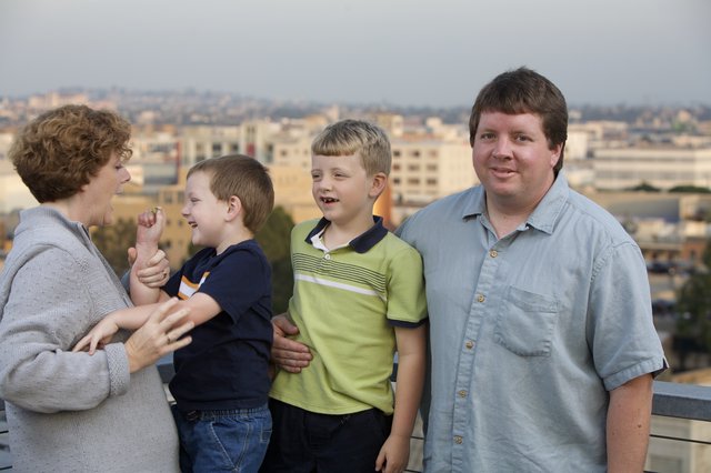 Family Portrait on Rooftop Overlooking City Skyline