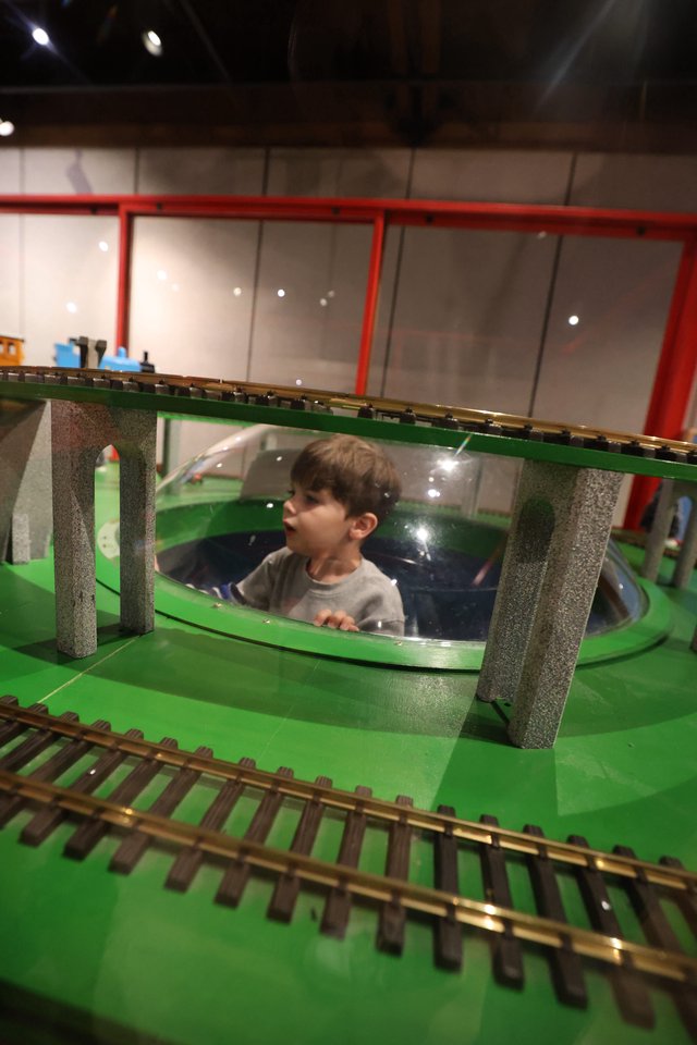 Child Exploring Interactive Train Museum Display