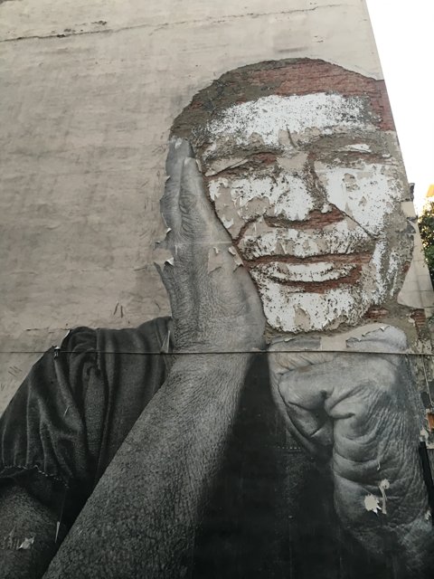 The Mural of a Bearded Man with his Hand on his Face