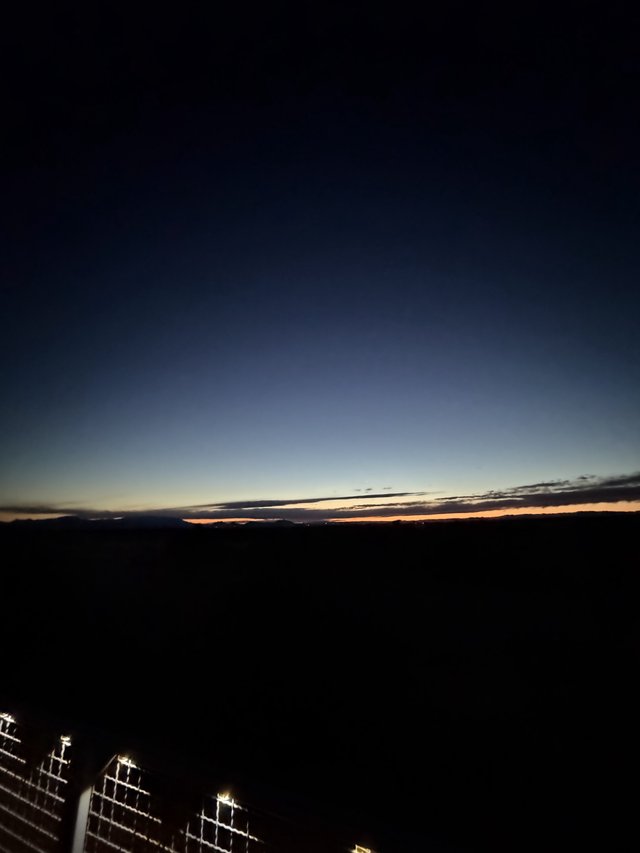 Twilight Glow Over Dark Desert Horizon