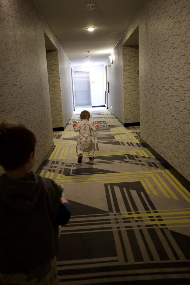 Children Playing in Modern Hotel Corridor at Dusk
