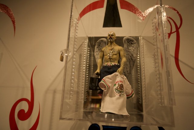 Statue of a Man with a T-Shirt in a Glass Case