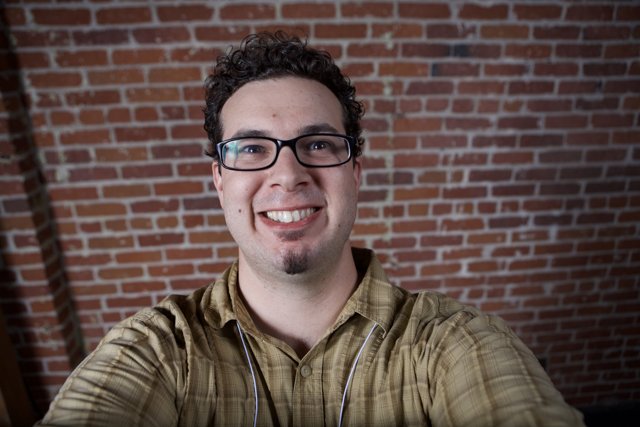 Happy Man in Plaid Shirt and Glasses