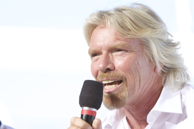 Richard Branson Takes the Stage with a Microphone