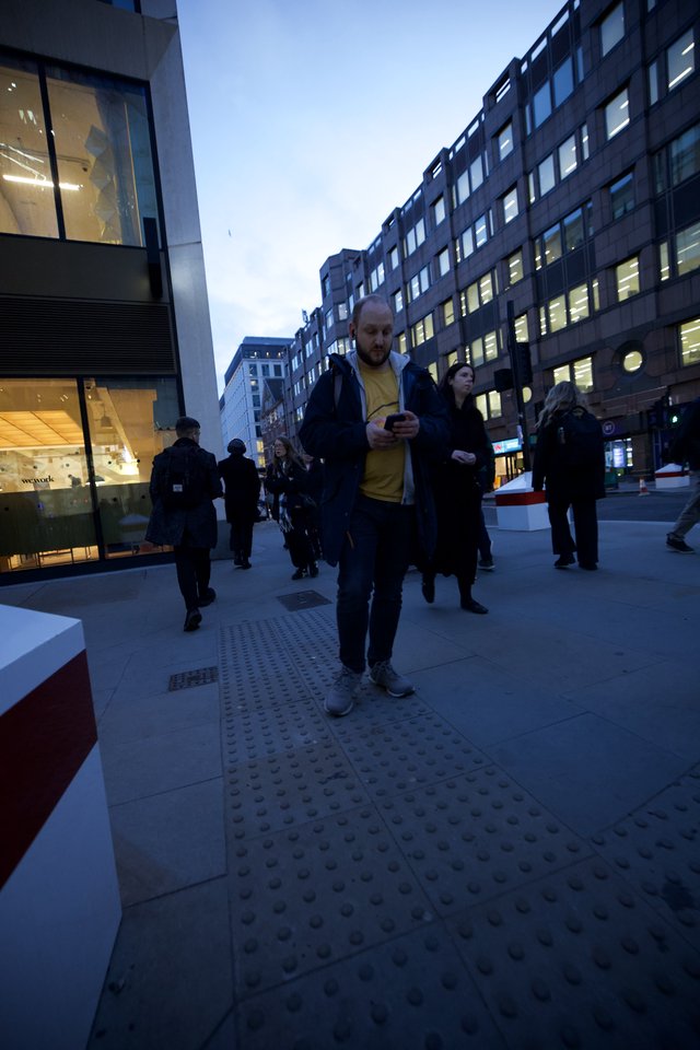 Urban Commuters on Modern London Street at Dusk