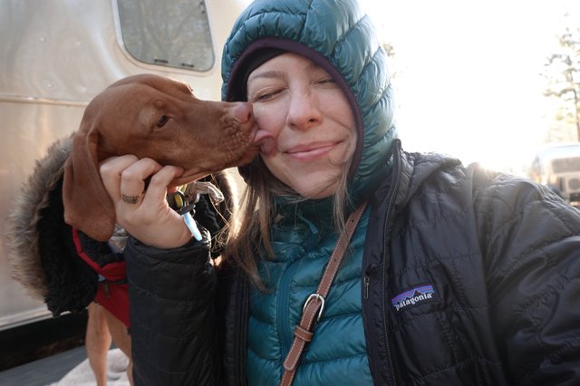 Woman and Dog Share Loving Moment Outside RV