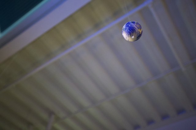 Earth Marble Suspended in Cosmic Blur