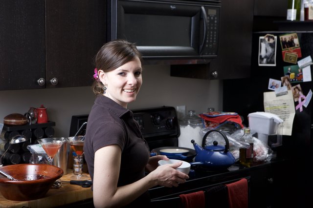 Smiling Woman Cooking in a Cozy Home Kitchen