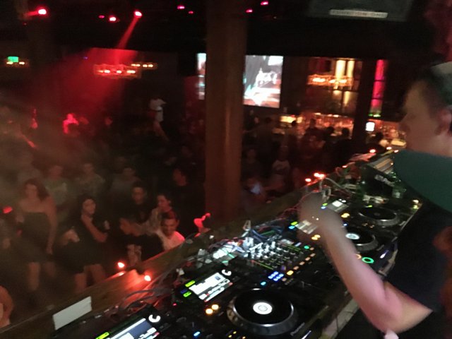 DJ spinning at crowded night club
