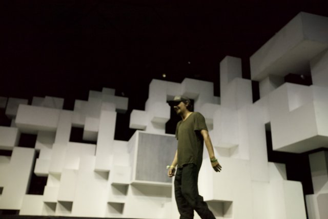 Man in Hat Dancing on White Cube Stage