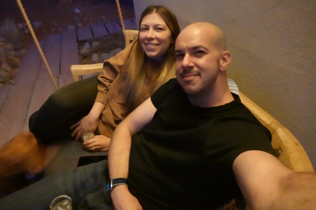 Couple Relaxing on Suspended Wooden Swing
