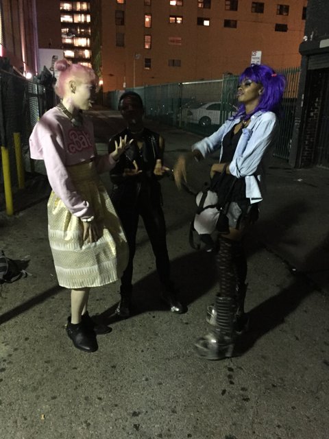 Purple-haired Duo on Urban Sidewalk