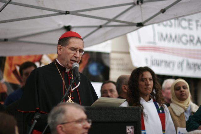 Bishop Roger Mahony Addresses Rally with Microphone