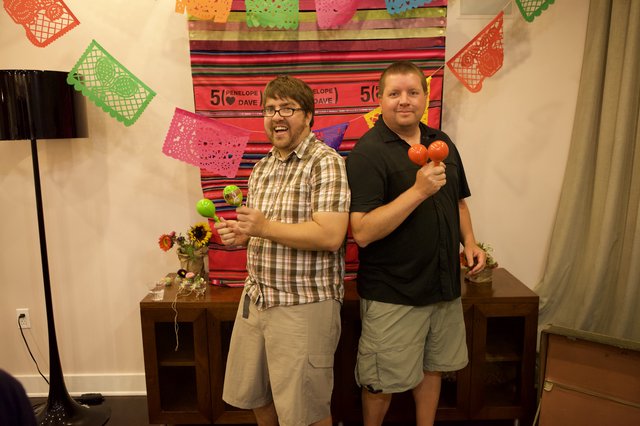 Two Friends Celebrate with Maracas at Fiesta Party