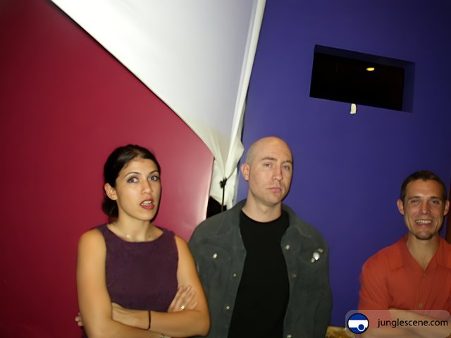 Three People In Front of a Purple Wall