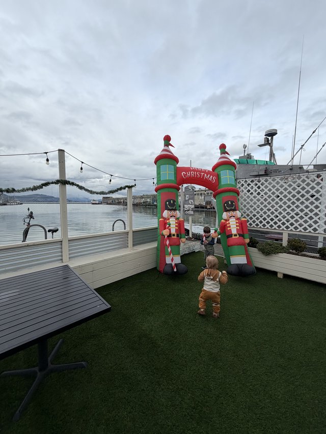 Toddler at Waterfront Christmas Display on Cloudy Day