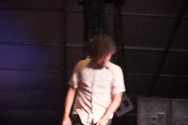Blurry Man on Stage with Mic
