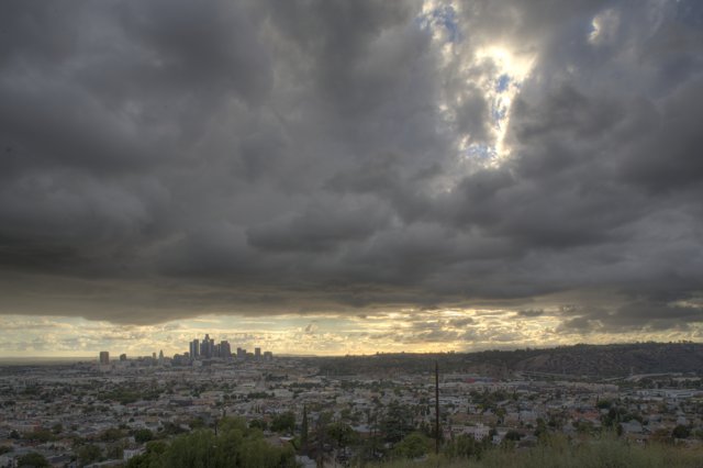 Urban Skyline Amidst Cumulus Clouds