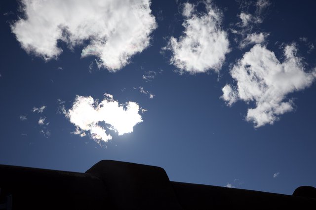 Silhouetted Adobe Architecture Against Bright Blue Sky