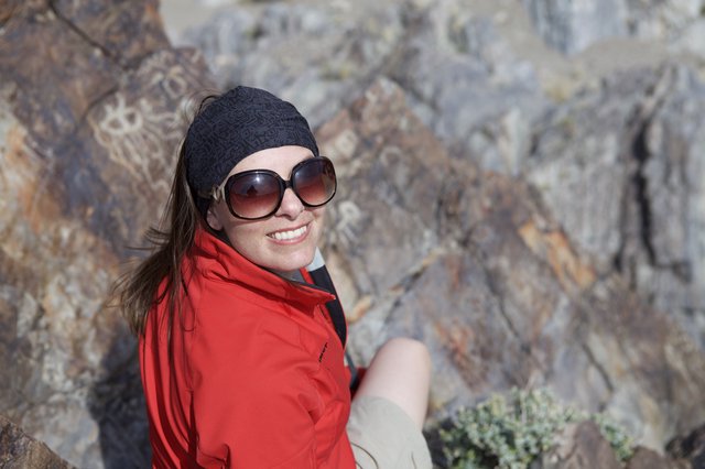 Smiling Hiker Pauses Among Desert Rocky Terrain