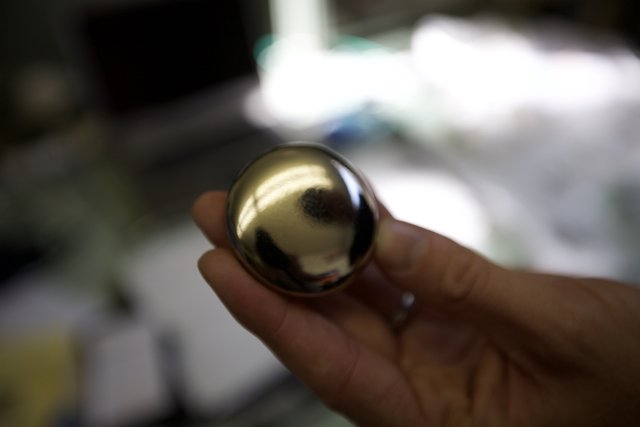 Shiny Sphere Held in Hand