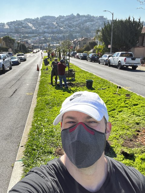 Man in Face Mask Walking Down Urban Street
