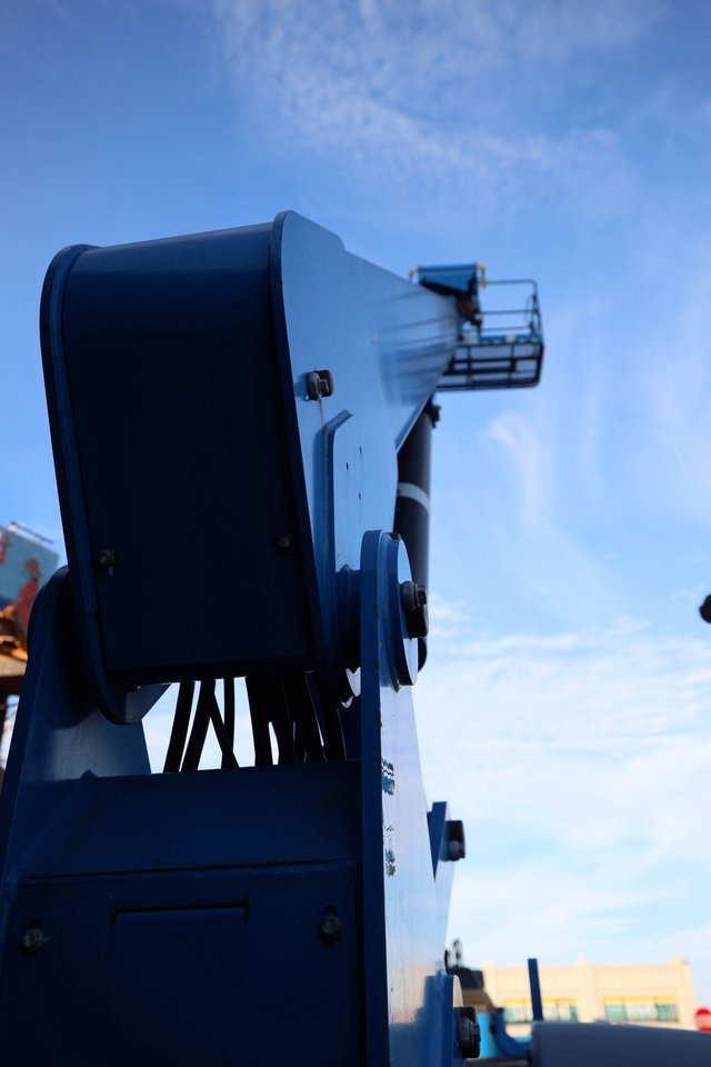 Blue Aerial Lift Platform Against Clear Sky