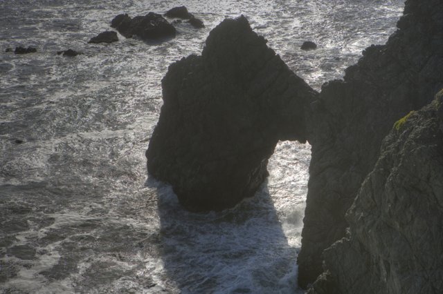 Majestic rock formation standing strong against the sea