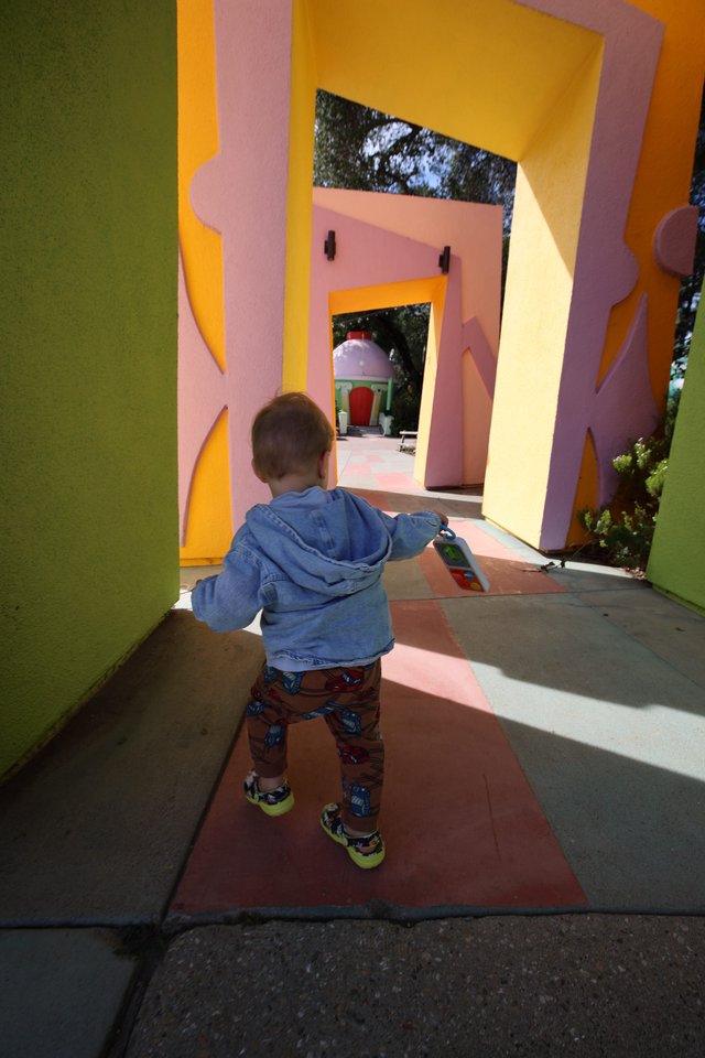 Child Exploring Colorful Architectural Play Structure