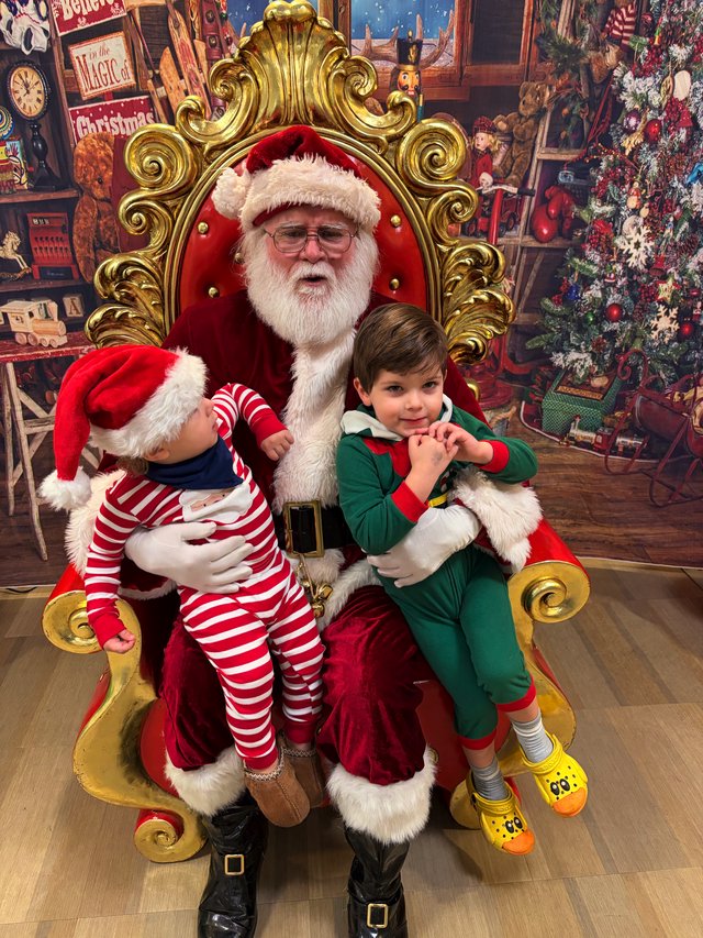 Two Children Visit Santa in His Ornate Christmas Throne