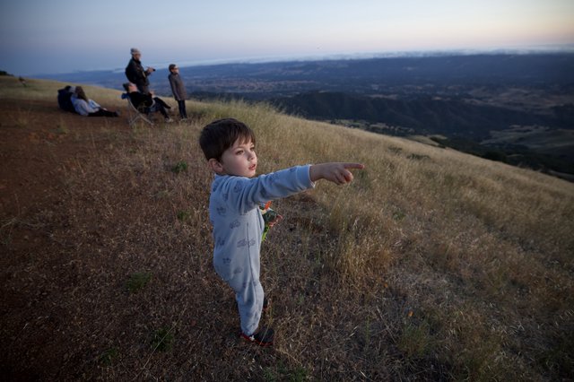 Young Explorer Points Toward the Valley Below