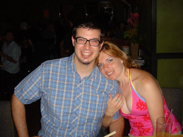 Couple Smiling Together at a Dimly Lit Restaurant