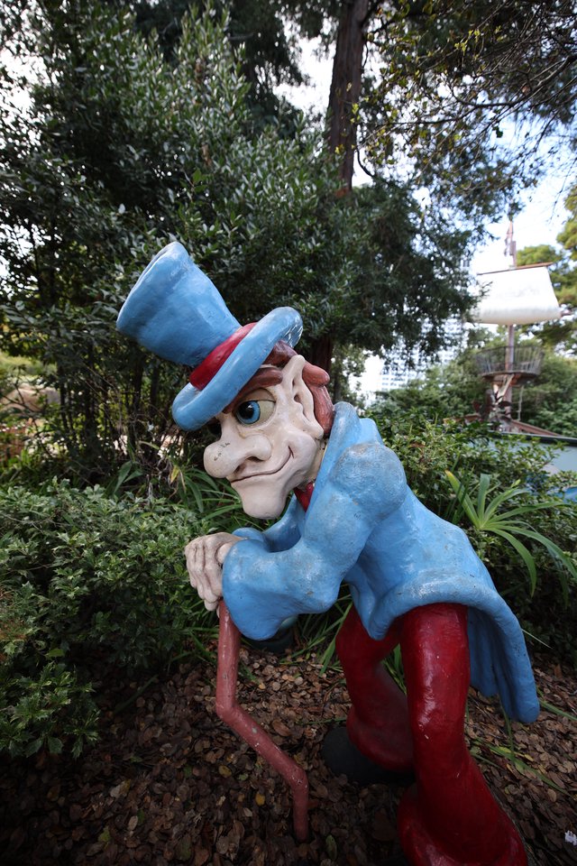 Weathered Uncle Sam Statue in Garden Setting