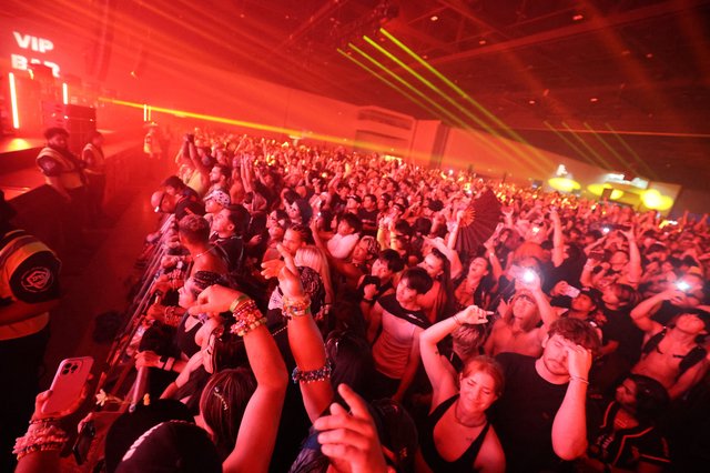 Massive Crowd Erupts Under Red Laser Light Show