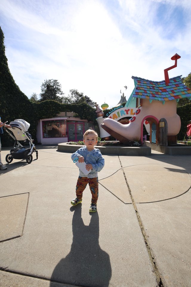 Toddler Explores Whimsical Fairytale Theme Park Area