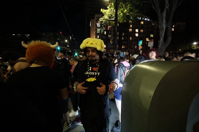 Festival Goer in Pompompurin Hat at Night Event