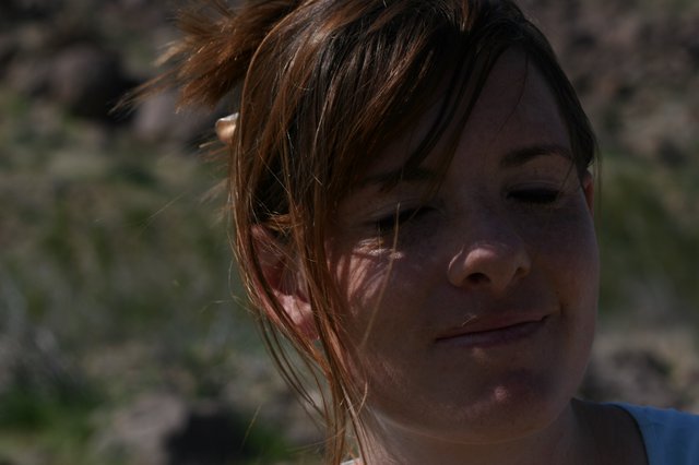 Wind-Swept Smile in Dappled Sunlight Outdoors