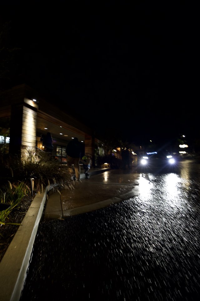 Emergency Vehicle Navigating Flooded Street at Night