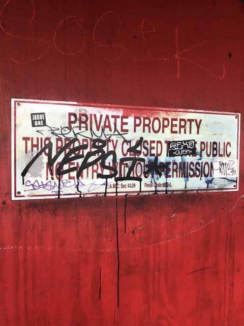 Defaced Red Sign