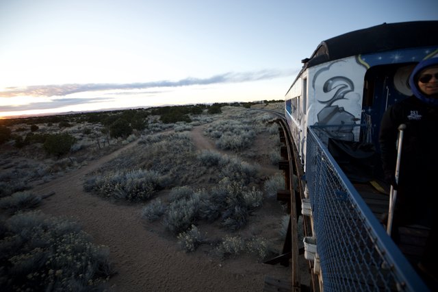 Sunset Train Journey Through Desert Landscape