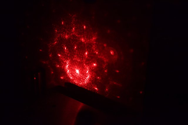 Red Laser Light Illuminates Wall